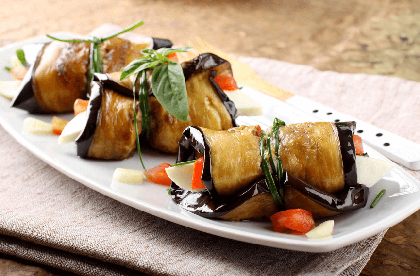 3 eggplant appetizers on a small white plate