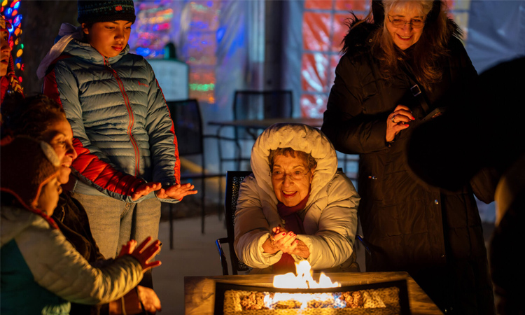Woman warming hands by fire