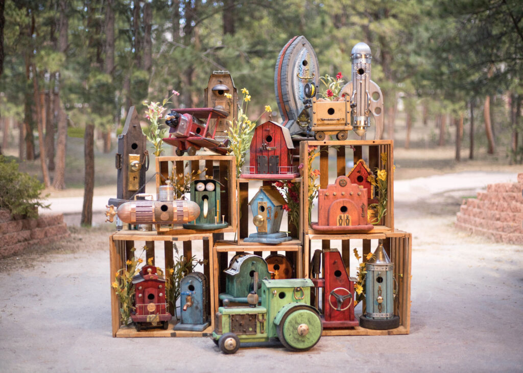 Display of colorful handmade bird houses