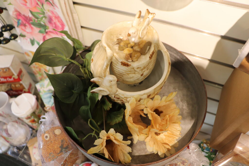 Small ceramic fountain with artificial flowers