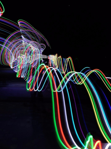 image of a painting done with light under the dark night sky