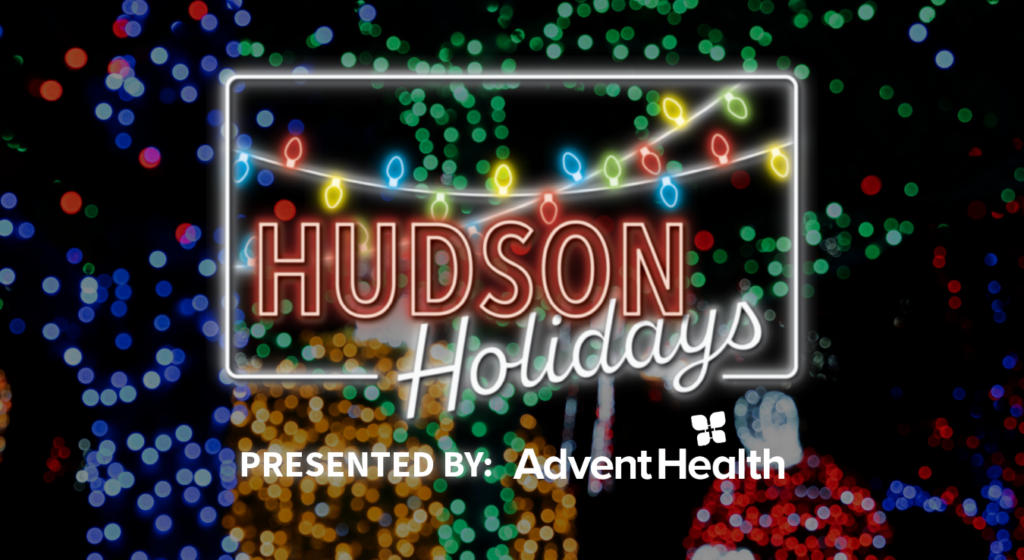 Glowing hudson holidays logo overlayed on background of christmas lights