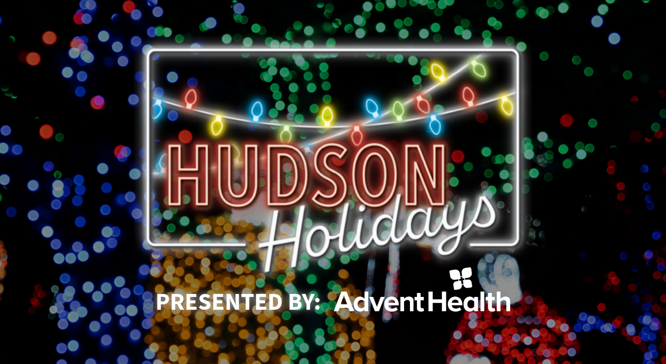 Glowing hudson holidays logo overlayed on background of christmas lights